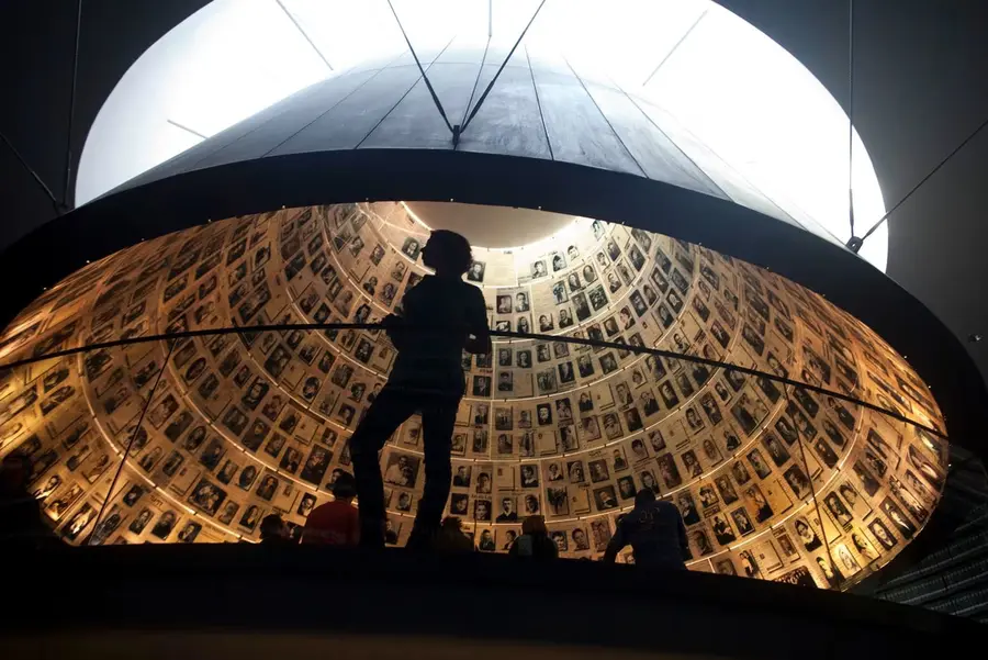 Person standing beneath a circular memorial installation
