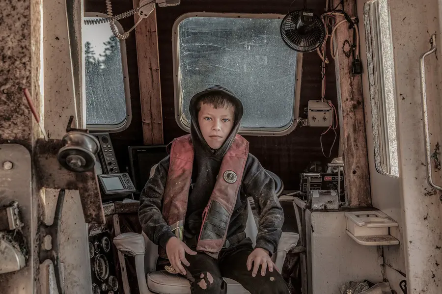 Young person aboard a working boat